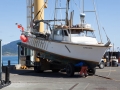 Fishing boat being hoisted onto dry dock at Port Orford