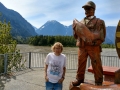 Kim & wooden sculpture by Fraser River at Hope, British Columbia