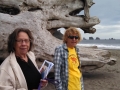 Mom & Kim at giant driftwood log on First Beach